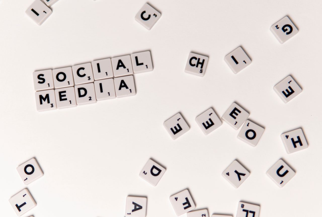about-us-01 Scrabble tiles spelling Social Media on a white background, symbolizing digital communication.